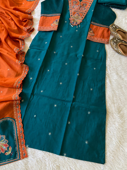 Traditional blue and orange saree with intricate patterns on a white surface