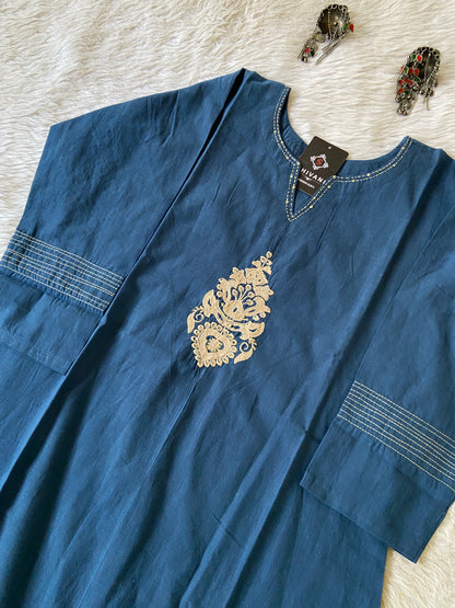 Blue shirt with gold embroidery on a light background