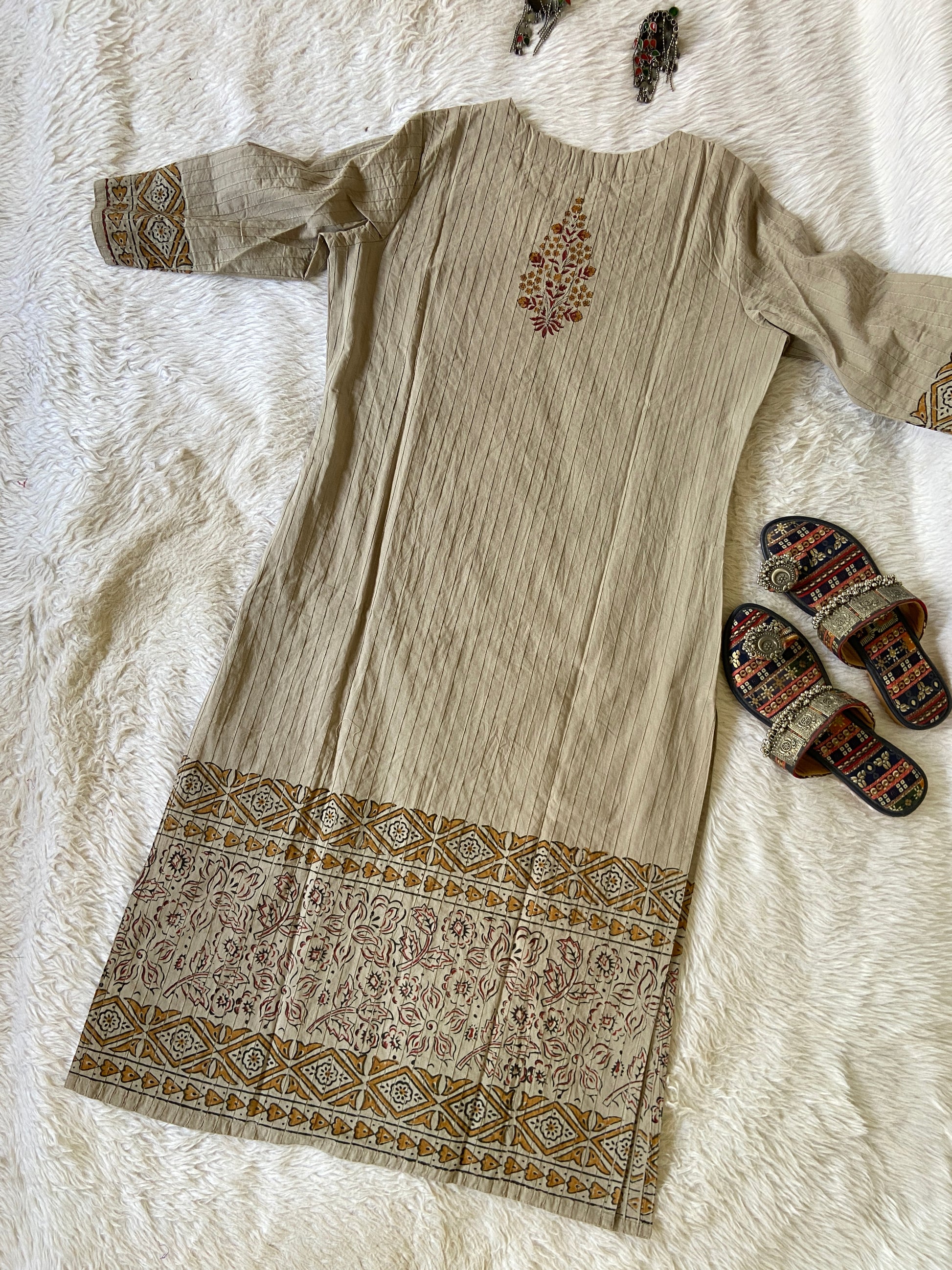Beige fabric with intricate patterns on a textured surface