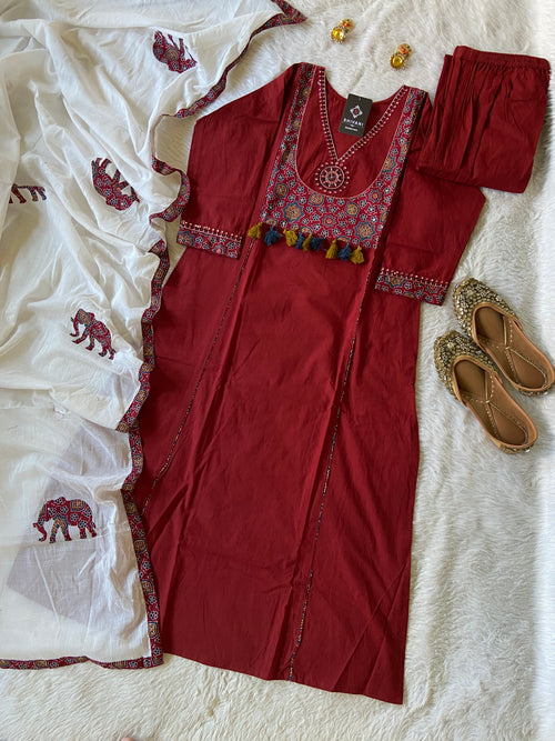 Red traditional outfit with white embroidered fabric on a light background