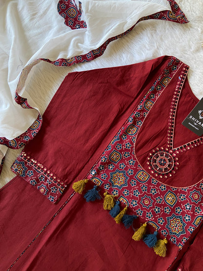 Maroon embroidered traditional outfit with white fabric underneath