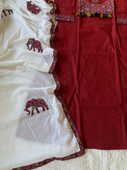 Red and white fabric with embroidered patterns on a textured surface