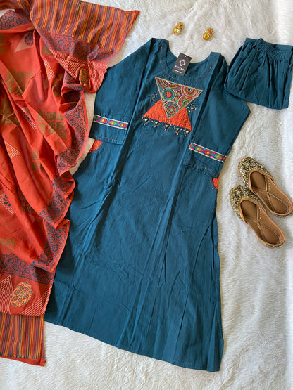 Blue dress with orange and red patterns on a white surface