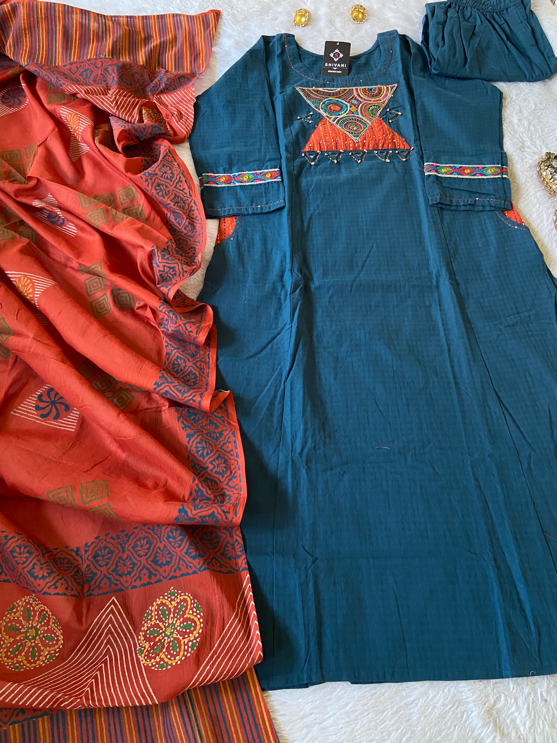 Blue and orange patterned shirts on a white surface