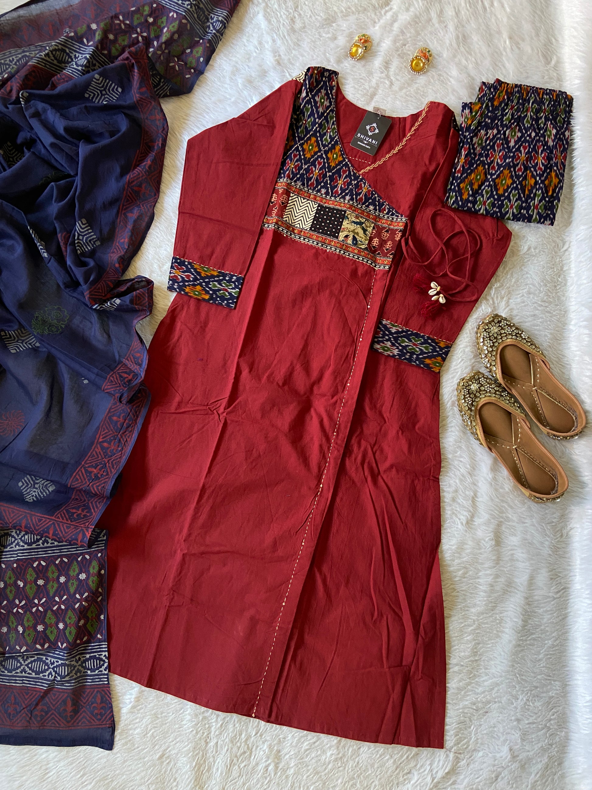 Red dress with intricate patterns on a white surface