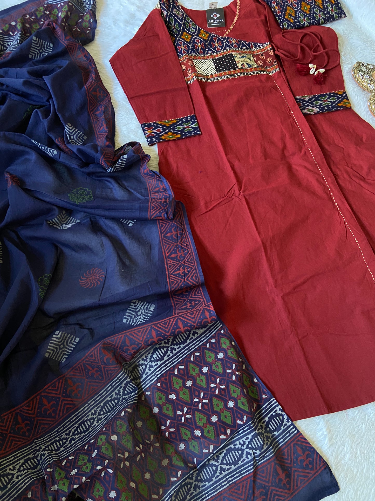 Red and patterned fabric pieces on a textured surface