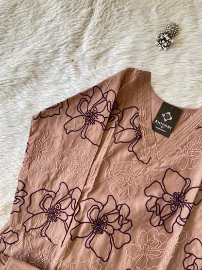 Brown fabric with floral patterns on a white fur surface