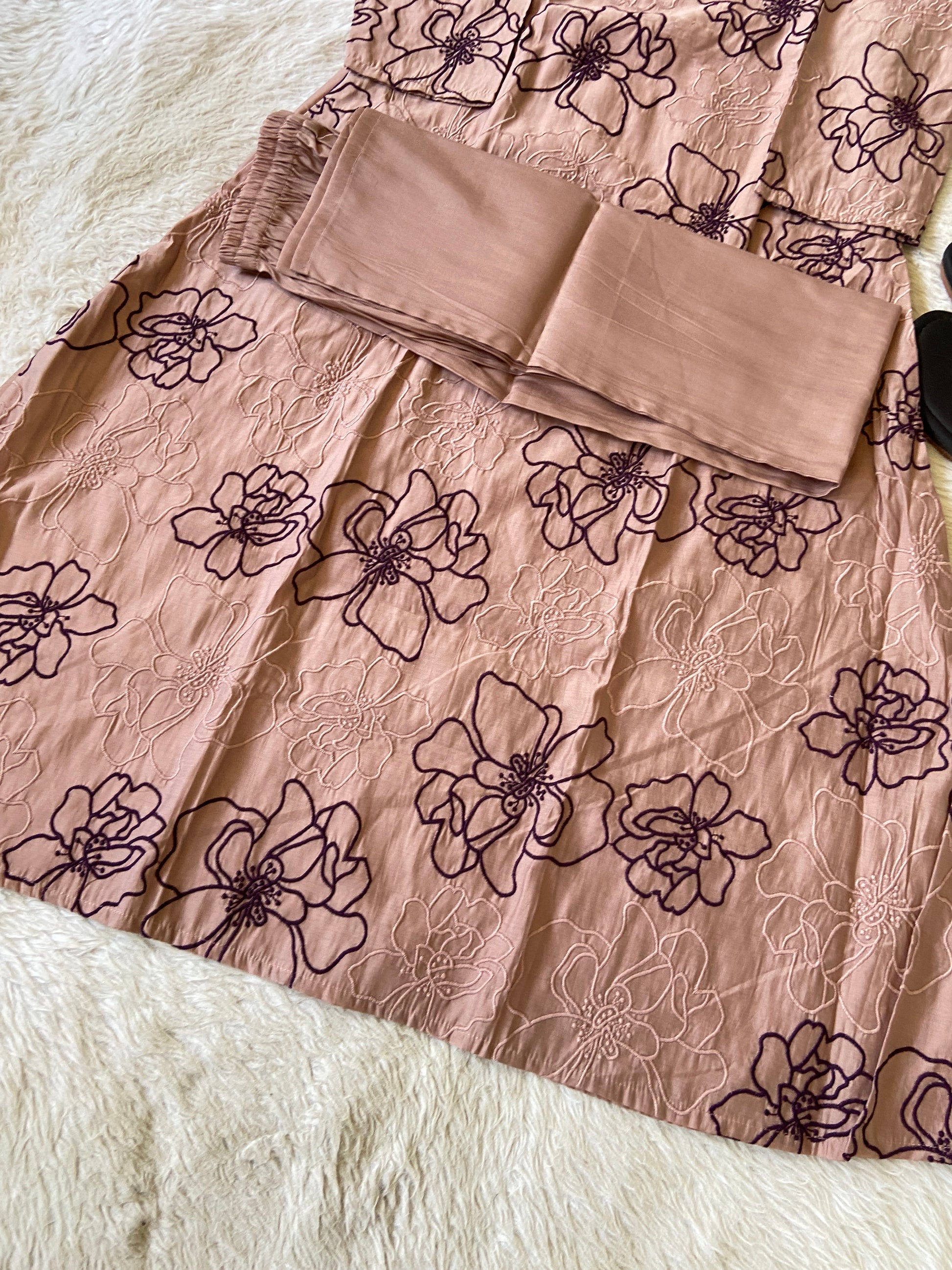 Beige scarf on a fabric with floral patterns