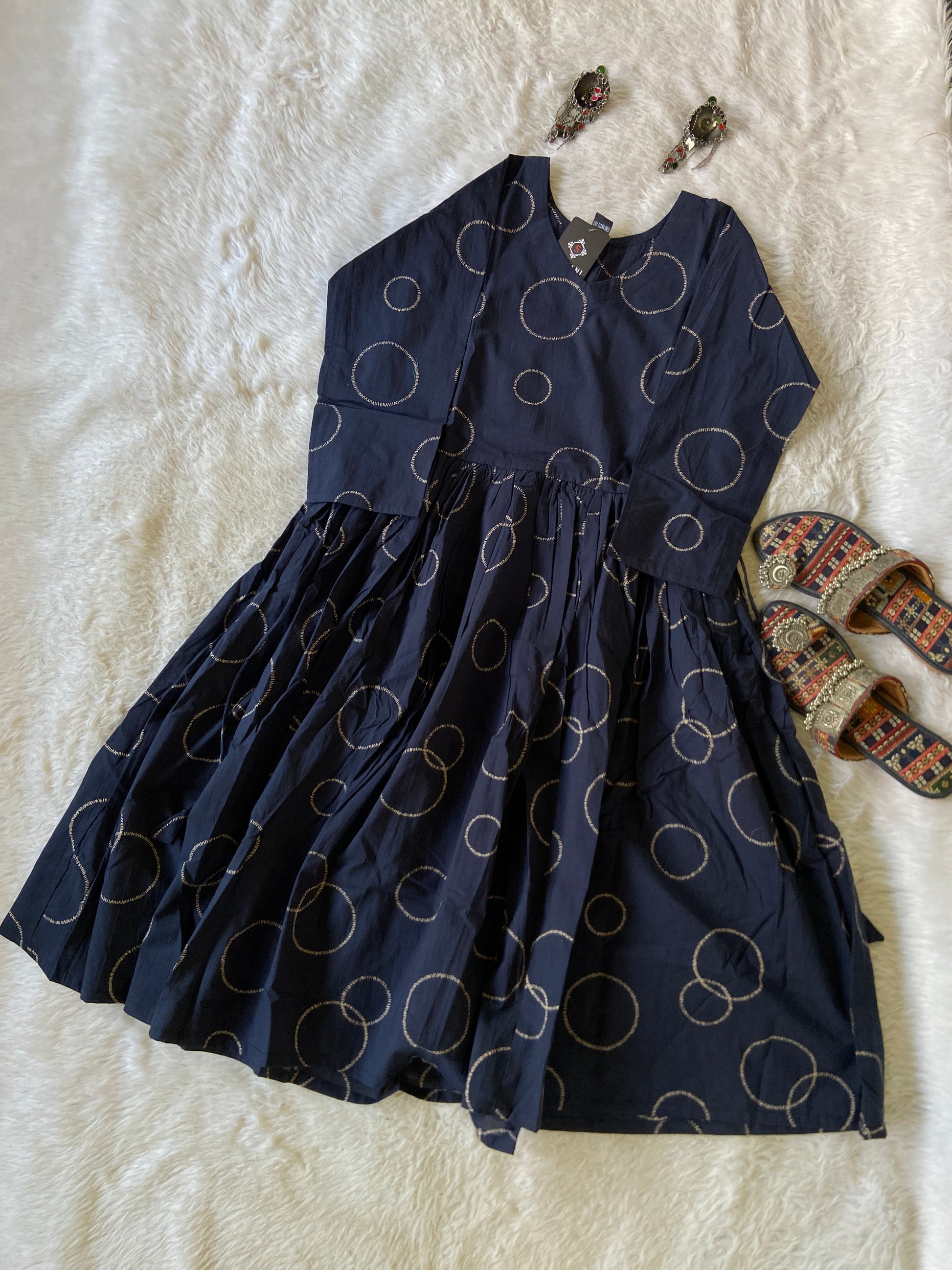 Navy blue skirt with circular patterns on a white textured surface