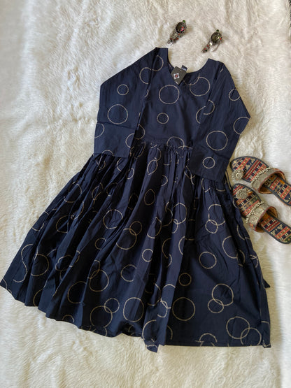 Navy blue skirt with circular patterns on a white textured surface