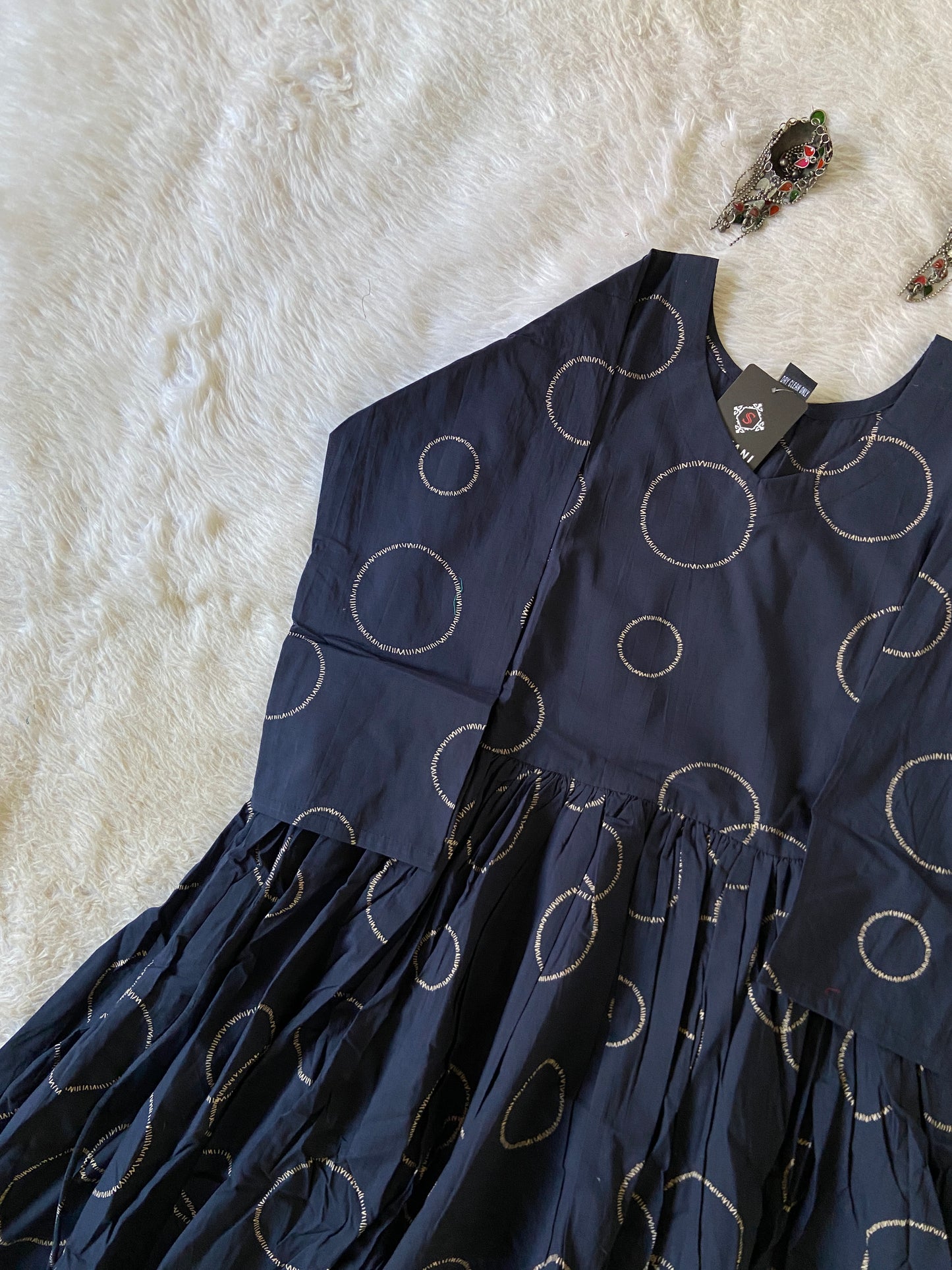 Navy blue fabric with circular patterns on a white surface