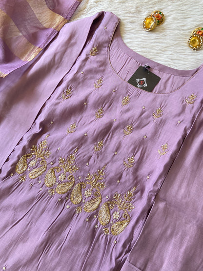 Purple dress with gold embroidery on a white surface