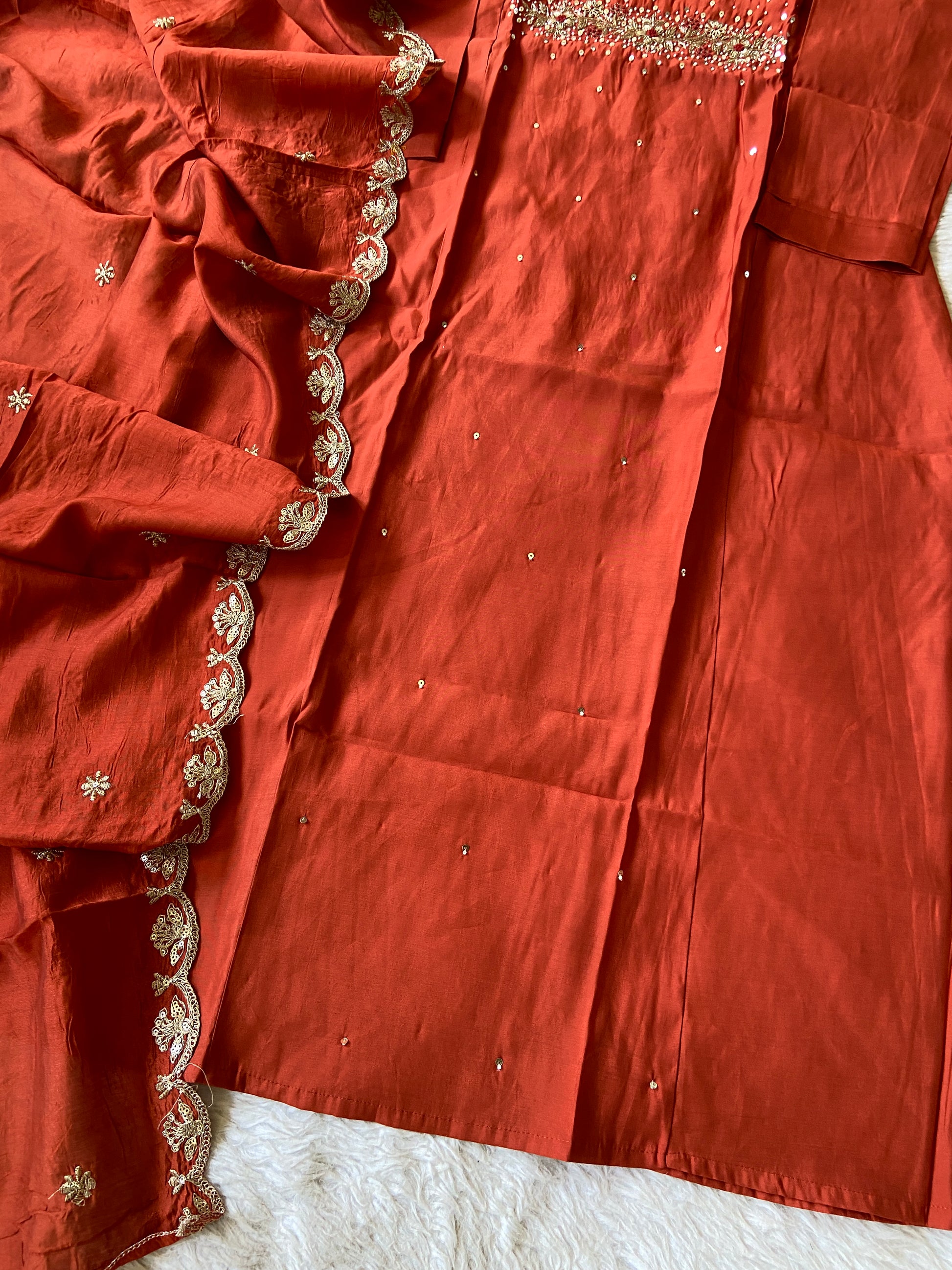Close-up of a red fabric with gold embroidery
