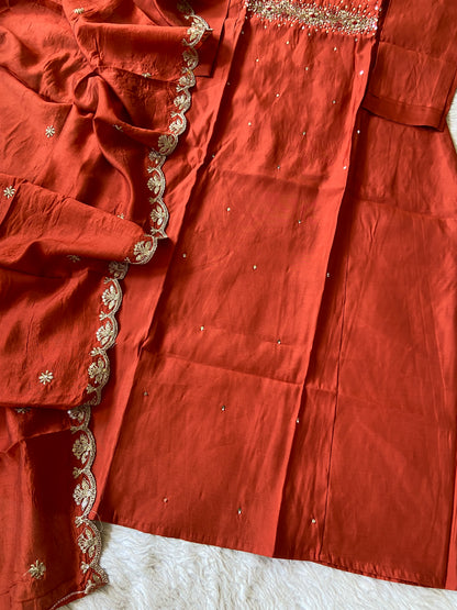 Close-up of a red fabric with gold embroidery