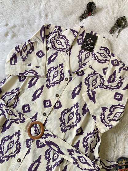 White shirt with purple geometric pattern on a textured surface