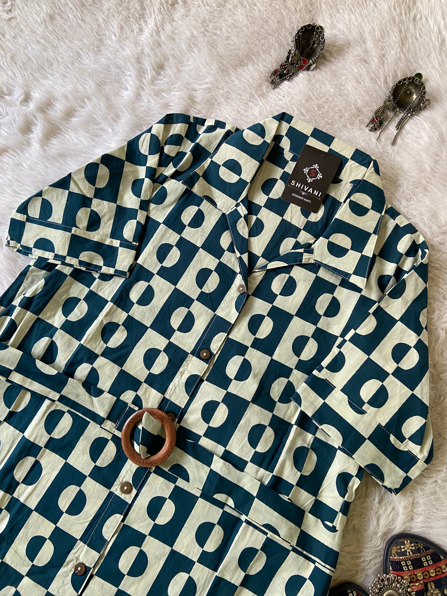 Blue and white patterned shirt on a textured surface
