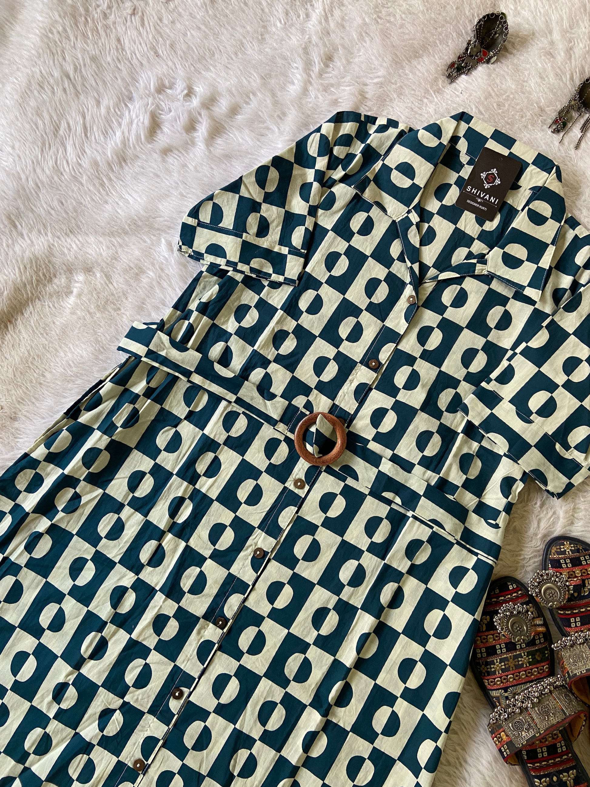 Patterned shirt on a textured surface with decorative items around