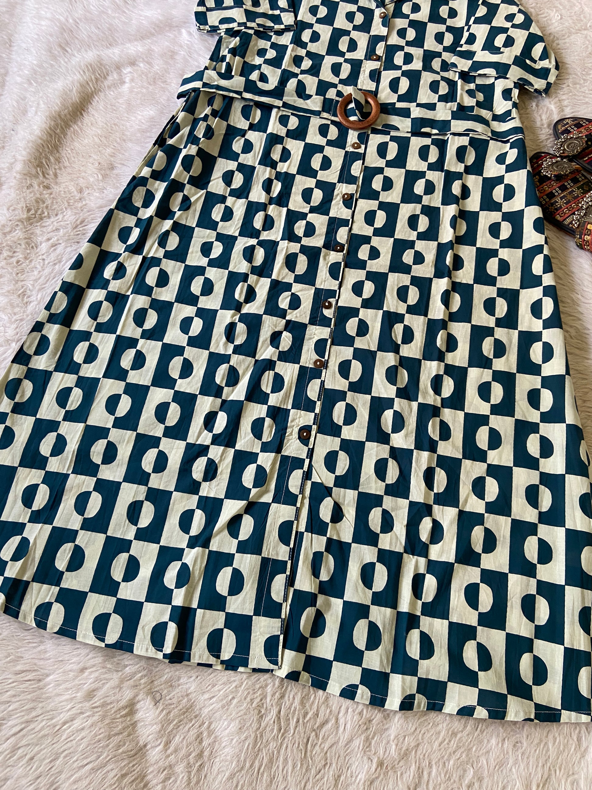 Folded fabric with a blue and white geometric pattern on a textured surface