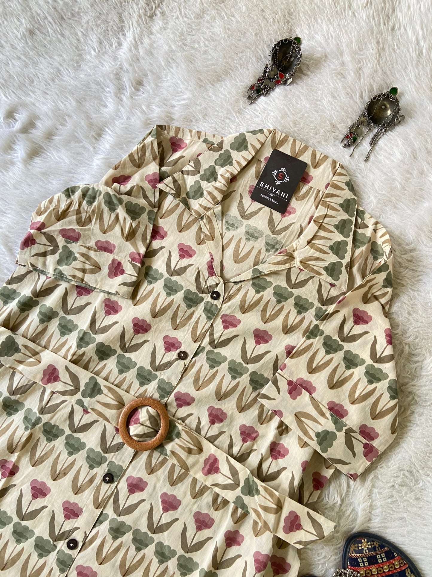 Floral-patterned tree skirt on a white surface with decorative elements.