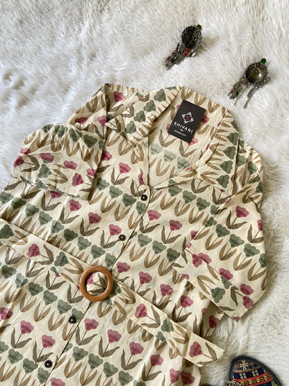 Floral-patterned tree skirt on a white surface with decorative elements.