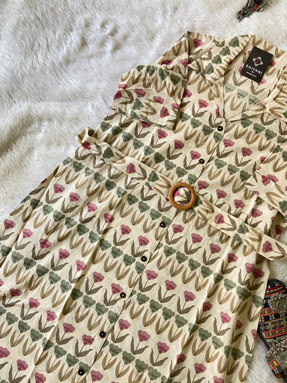 Floral patterned shirt with a tag on a textured surface