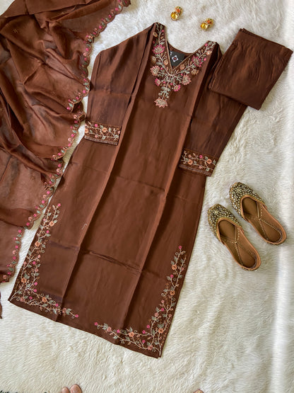 Brown embroidered outfit with matching shoes on a light background