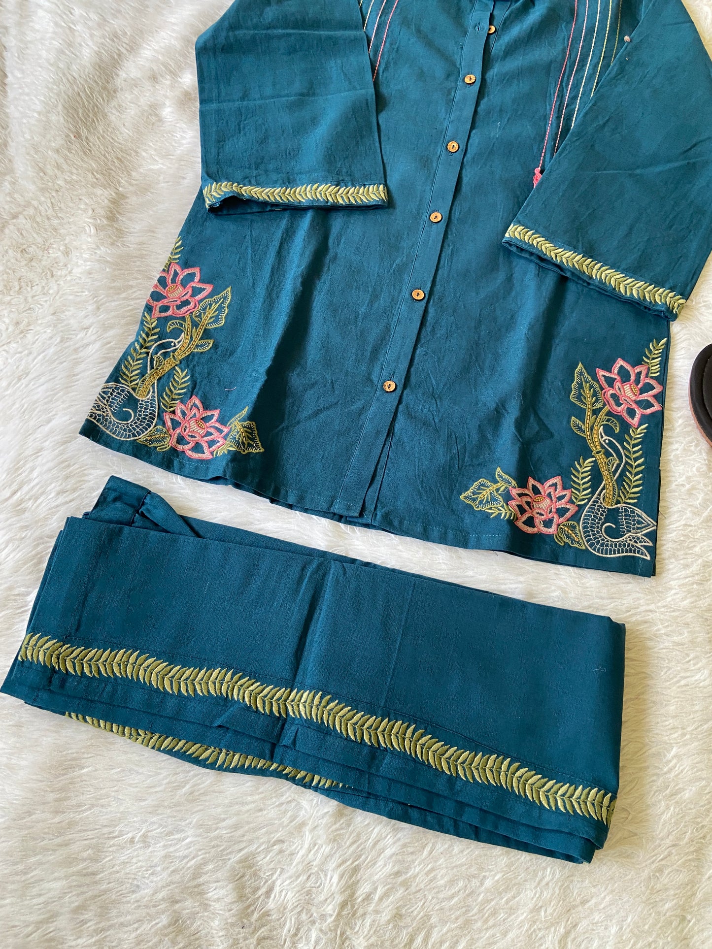Blue embroidered fabric on a white surface