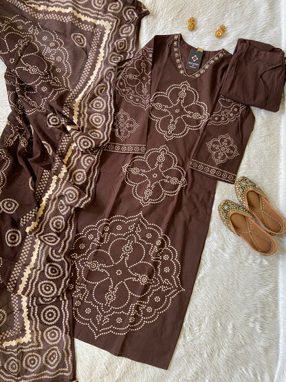Brown outfit with intricate white patterns on a textured surface
