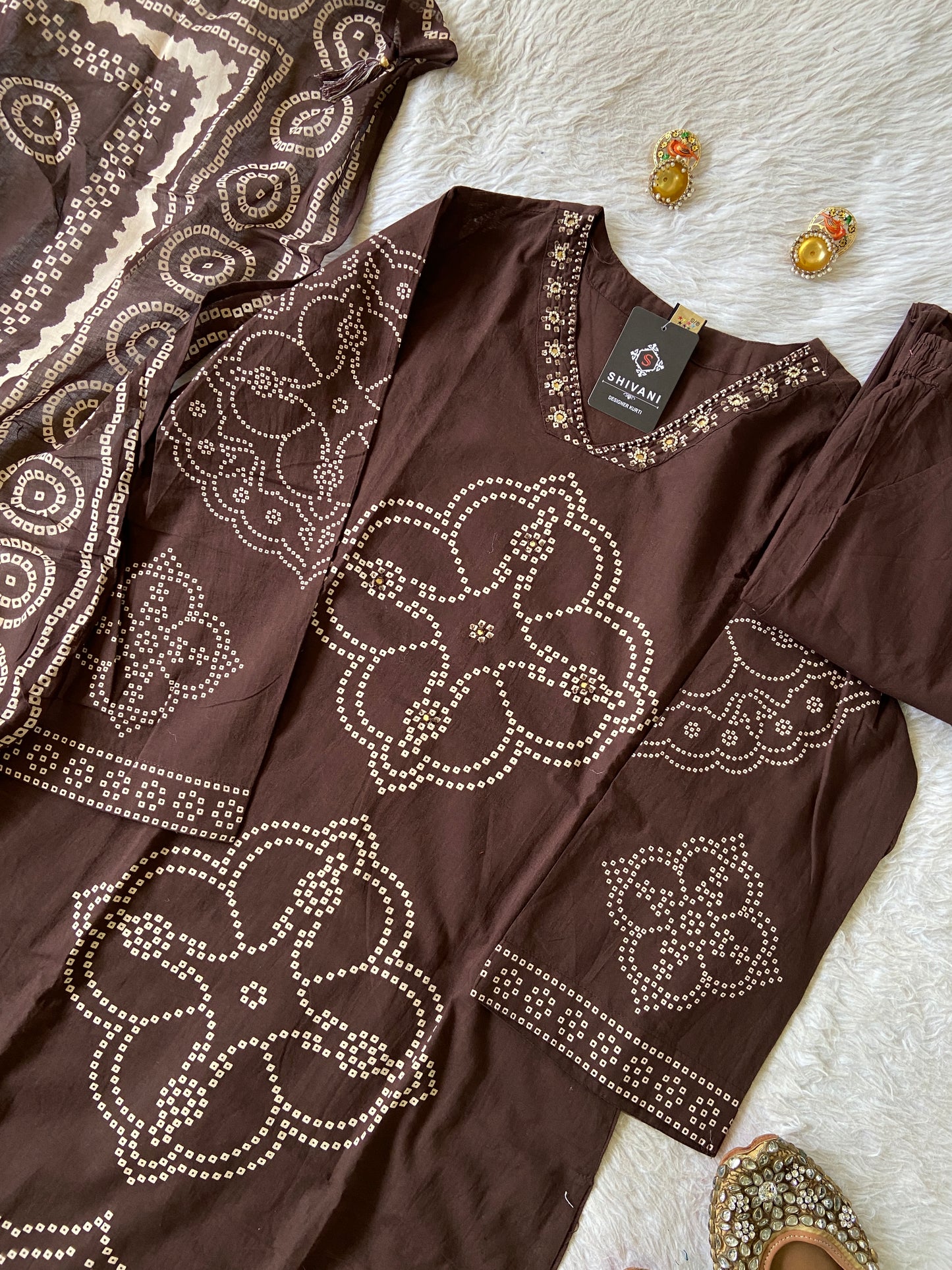 Brown dress with decorative patterns on a white surface