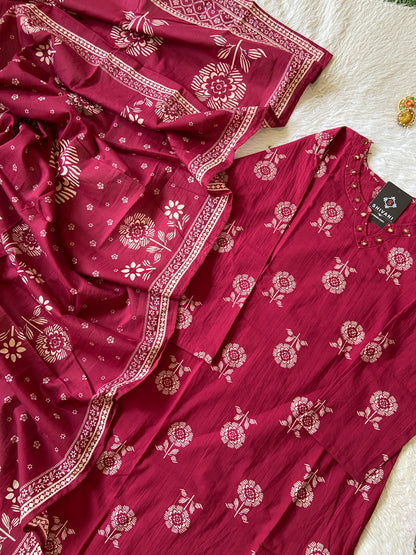 Red floral patterned fabric with a matching dress on a light background