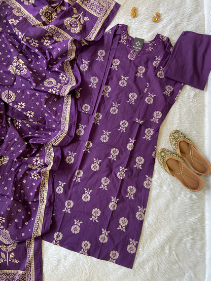 Purple saree with floral patterns on a white surface