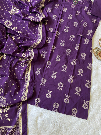 Purple saree with white floral patterns on a textured surface