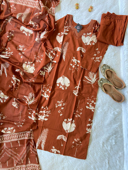 Brown floral dress with matching shoes on a white surface