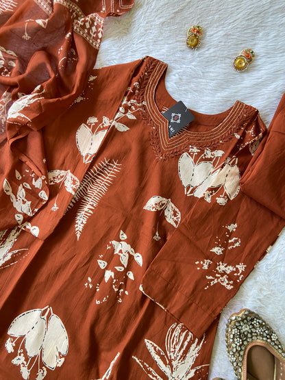 Brown fabric with white floral patterns on a textured surface