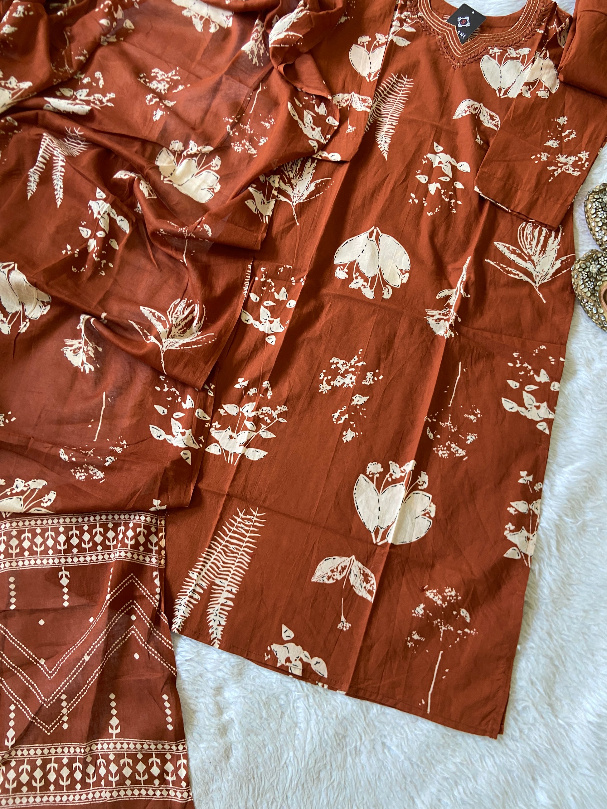 Red patterned garment on a white surface