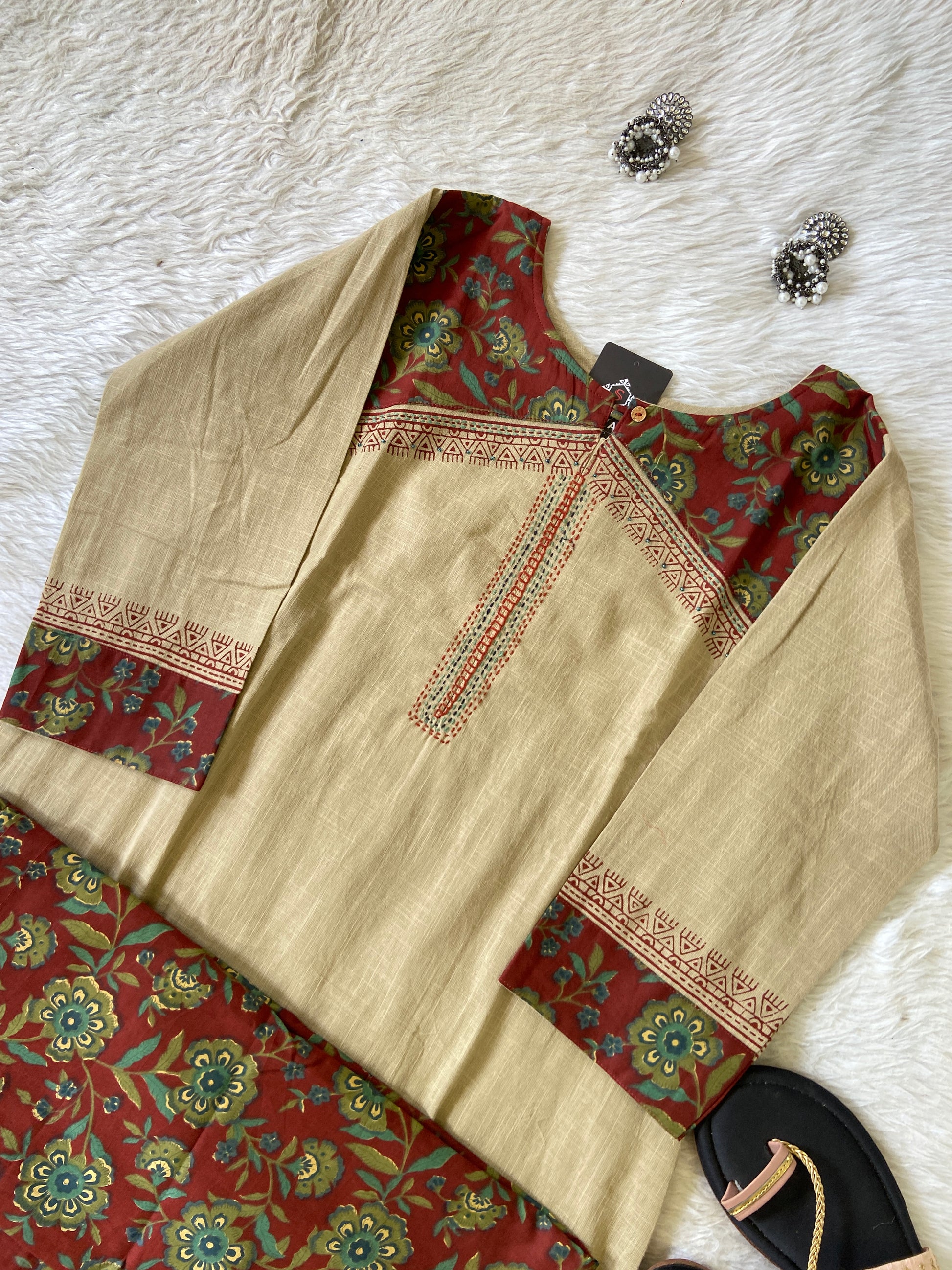 Traditional outfit with embroidered top and skirt on a textured surface